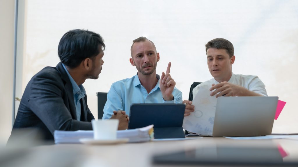 group of diverse businessman going over paperwork 2023 11 27 05 14 49 utc scaled